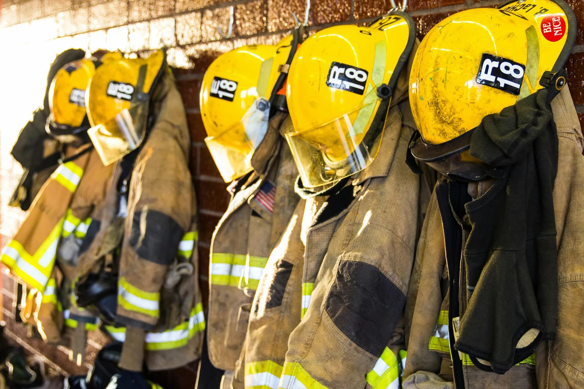 Firefighter turnout gear hanging in a fire station